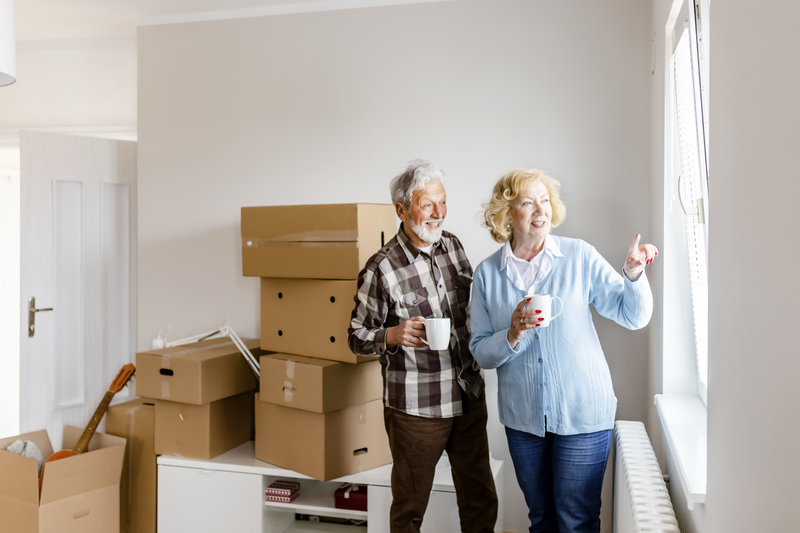Senior Couple at Moving Day Looking Through the Window